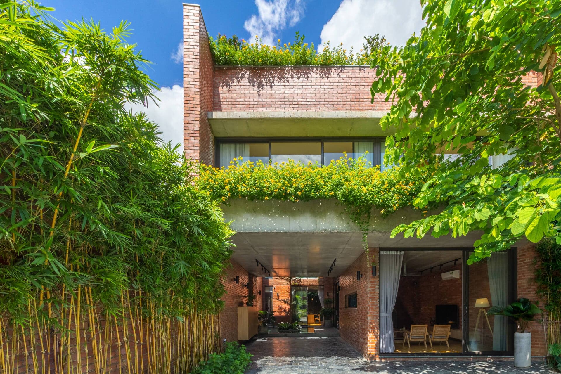 Cao Xanh House - Nhà gạch đỏ được bao phủ bởi cây xanh xuyên suốt chiều dài 25m