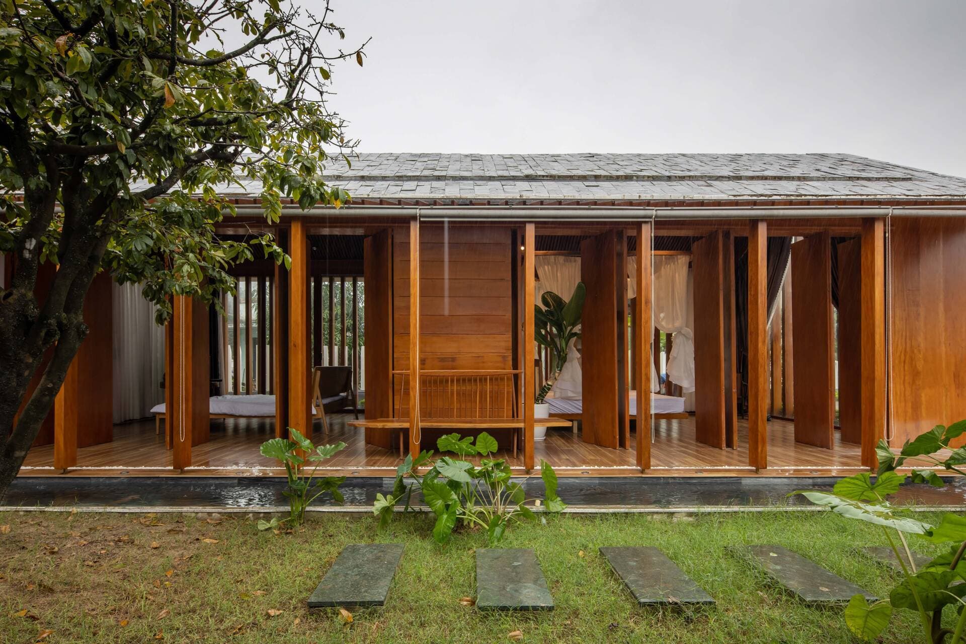 The Village House - Nhà ba gian làm chủ yếu từ gỗ mít, gỗ keo vàng, vẫn đón sáng tự nhiên ngay cả khi đóng hết cửa